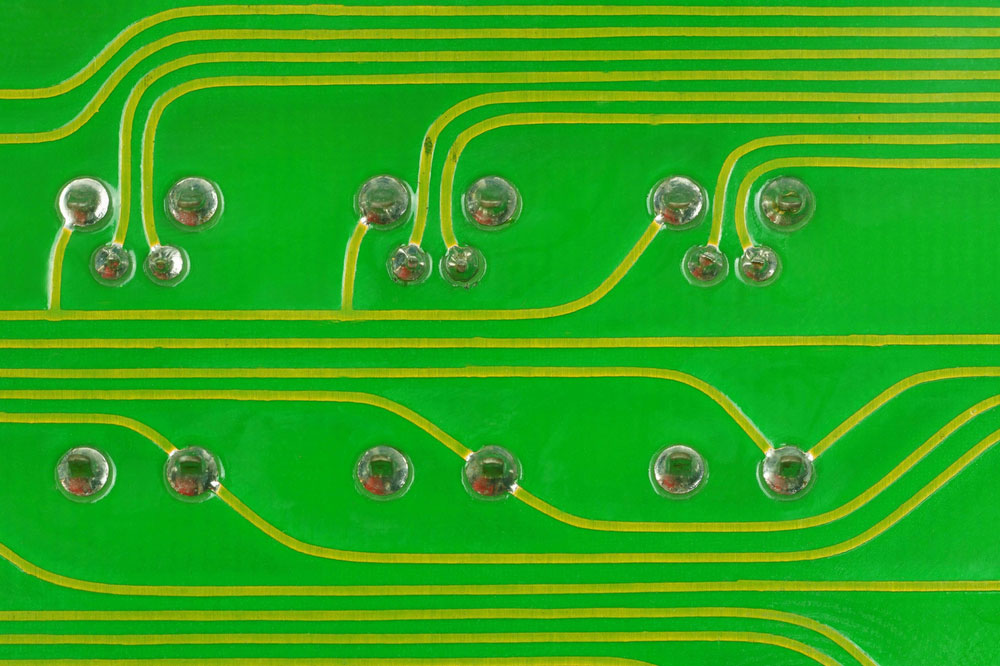 Close-Up a lead solder a pin of a LED and a transistor on a pcb board.