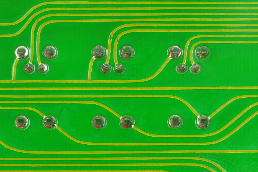 Close-Up a lead solder a pin of a LED and a transistor on a pcb board.