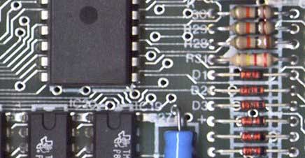 A printed circuit board showing drill areas and conductive traces