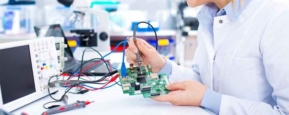 A female engineer working on a PCB