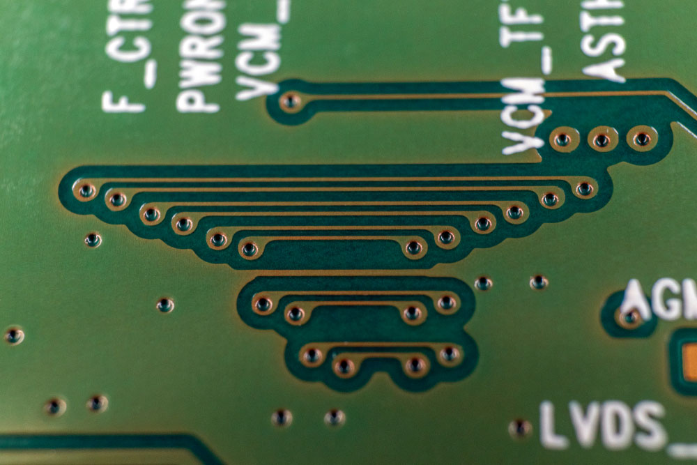 A printed circuit board showing printed traces along the through-holes