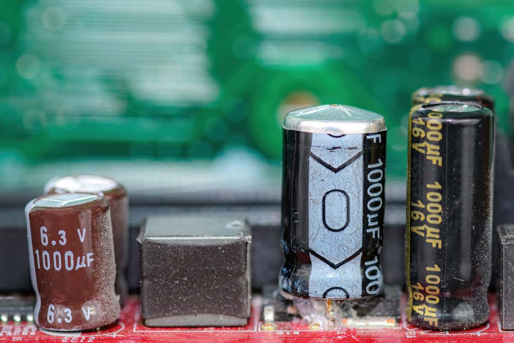 Troubleshooting Printed Circuit Board Capacitor Issues Capacitors on PCBs can fail and exhibit either of these issues if defective or damaged. Low internal resistance: Indicates an internal short circuit. Replace it with a low-resistance capacitor. High resistance or zero continuity: Open circuit Bulging, cracking, drying out, or fluid leakages in electrolytic capacitors: Indicates the end-of-life (needs a replacement) https://www.shutterstock.com/image-photo/damaged-capacitor-on-circuit-board-top-2002514951 A bulged capacitor on a PCB Excessively high discharge voltage when unpowered: Leaking dielectric Low capacitance: Worn-out dielectric Overheating: Ripple current or excessive ESR. Replace it with a capacitor rated for high ripple current. 