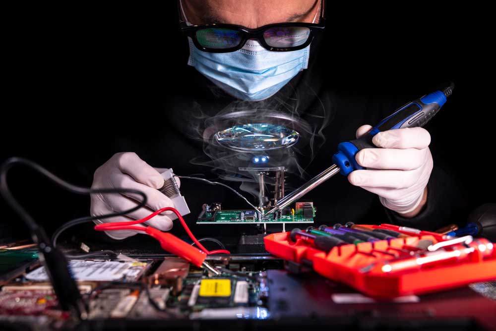 A PCB engineer in the soldering process