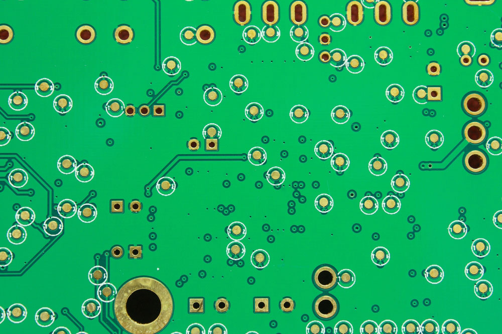 A PCB board with several pads. Note the thermal pad with spokes on the upper left section
