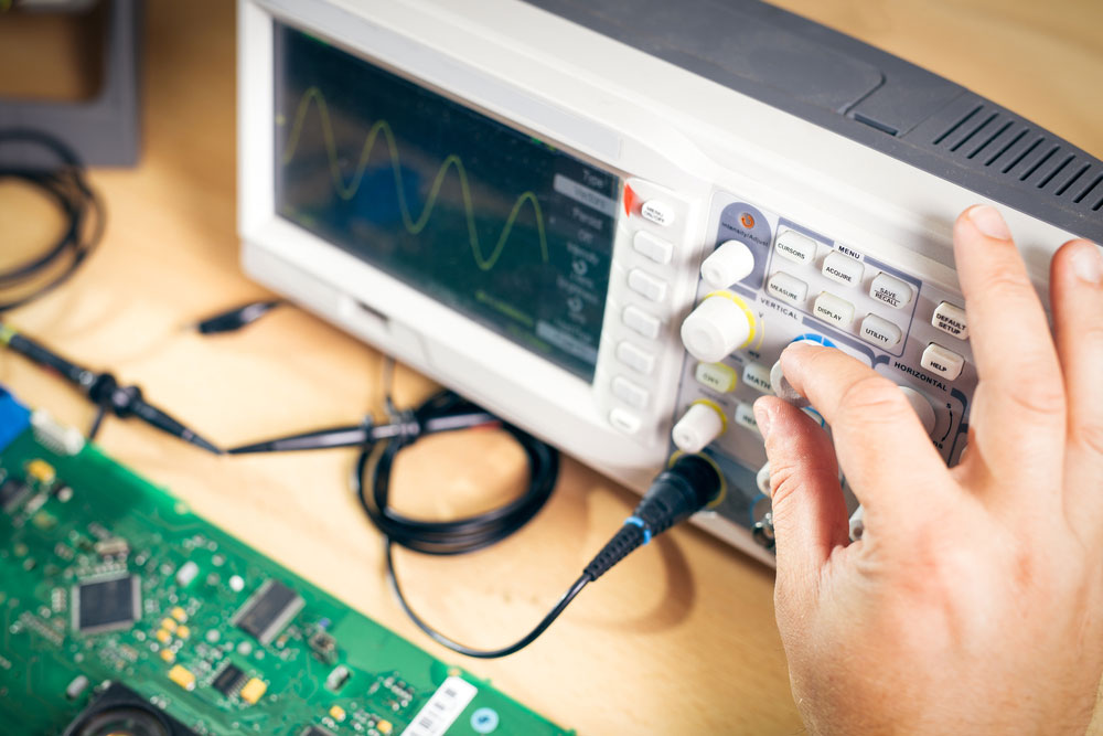 An engineer testing electronic components in a PCB