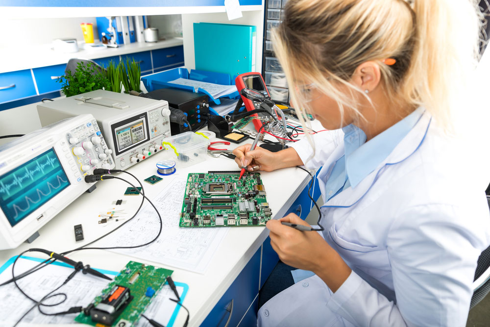An engineer troubleshooting issues in a PCB’s electronic components
