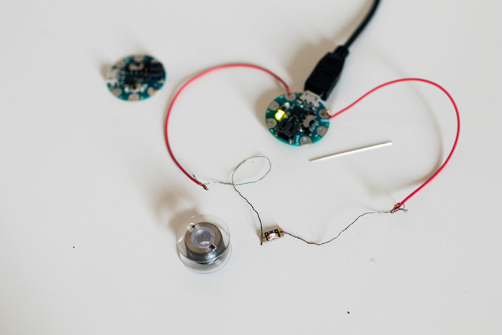 A prototype of a wearable device with a home-made sewable microcontroller