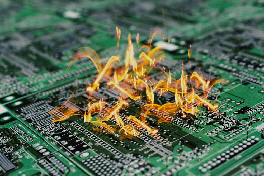 A PCB is on fire due to short-circuiting.