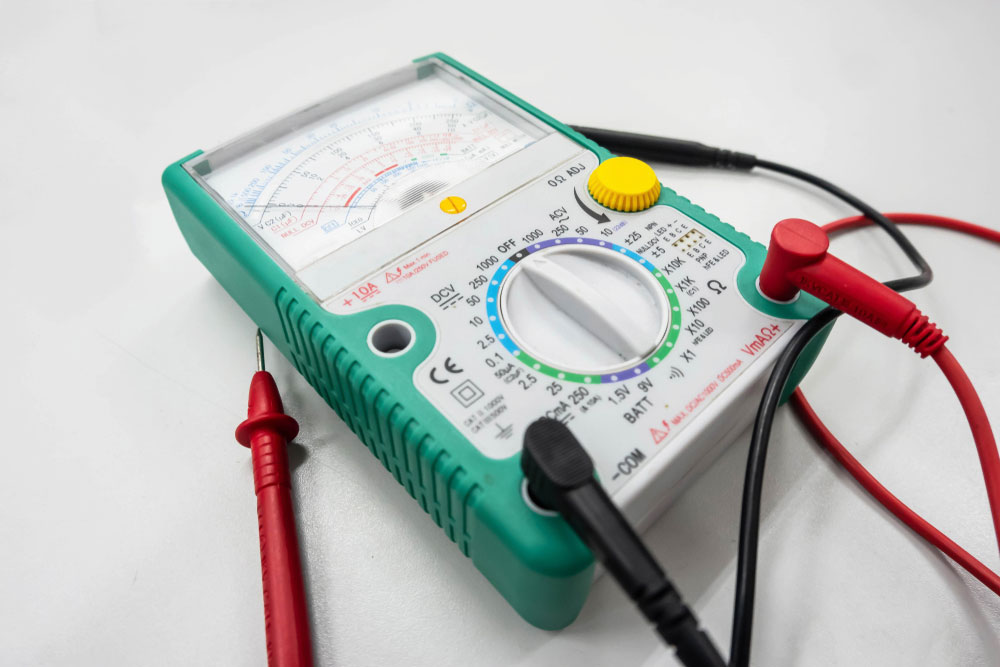 A digital multimeter with four ports (the VΩ and mA ports are separate)