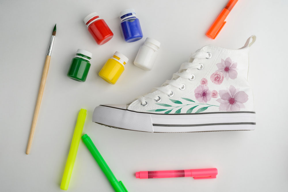 Fabric paint used to decorate canvas sneakers.