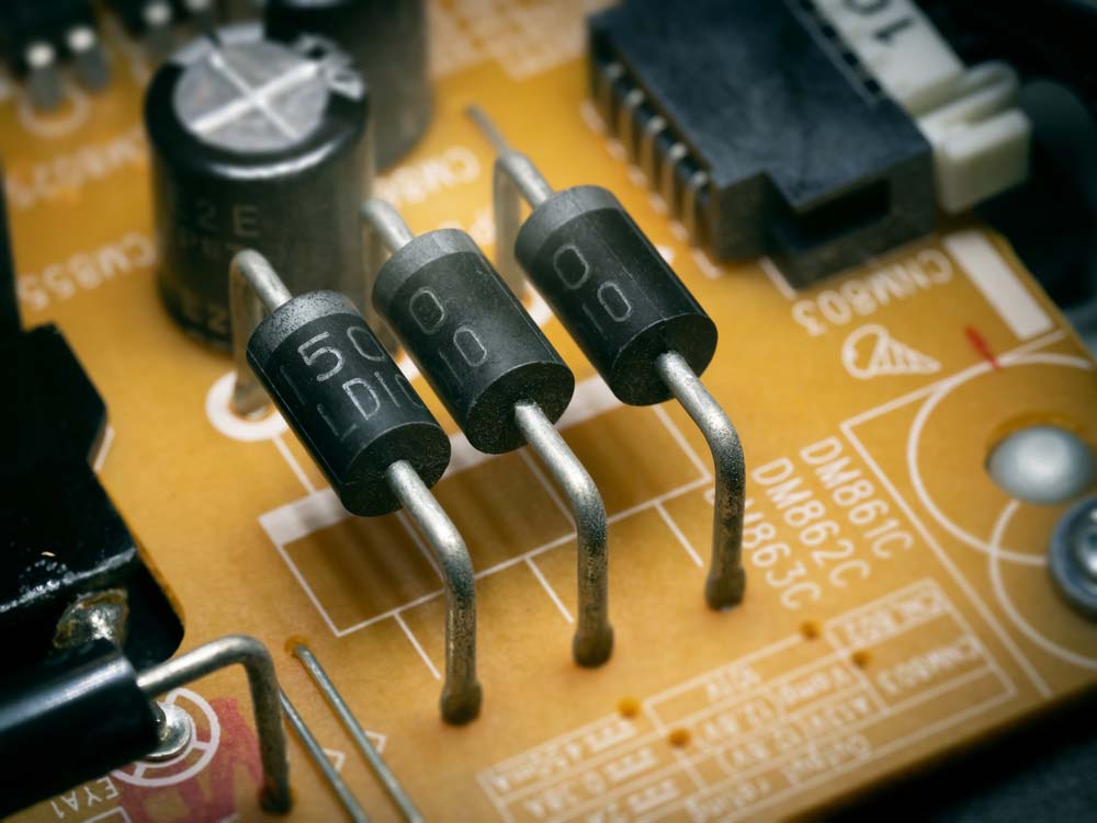 Three through-hole diodes soldered on a PCB.