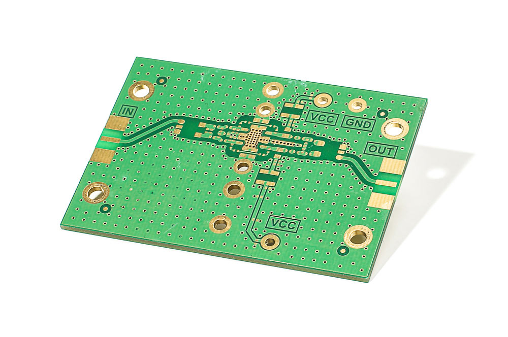 A radio frequency amplifier PCB with a plated-through via to access the ground plane