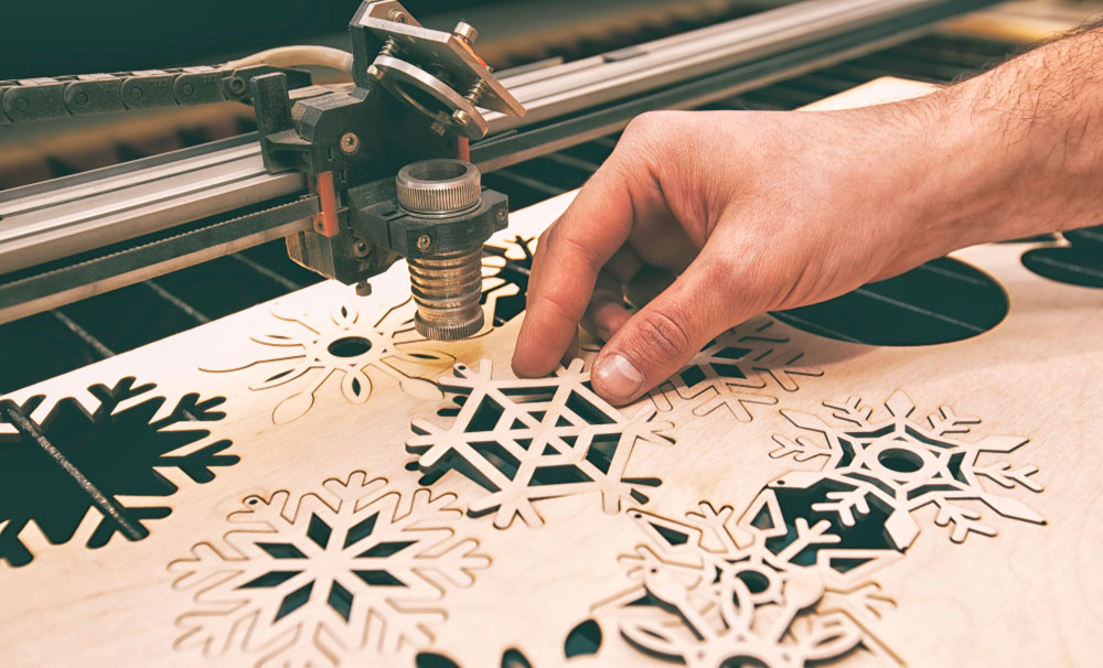 Intricate snowflake designs created by a laser cutter