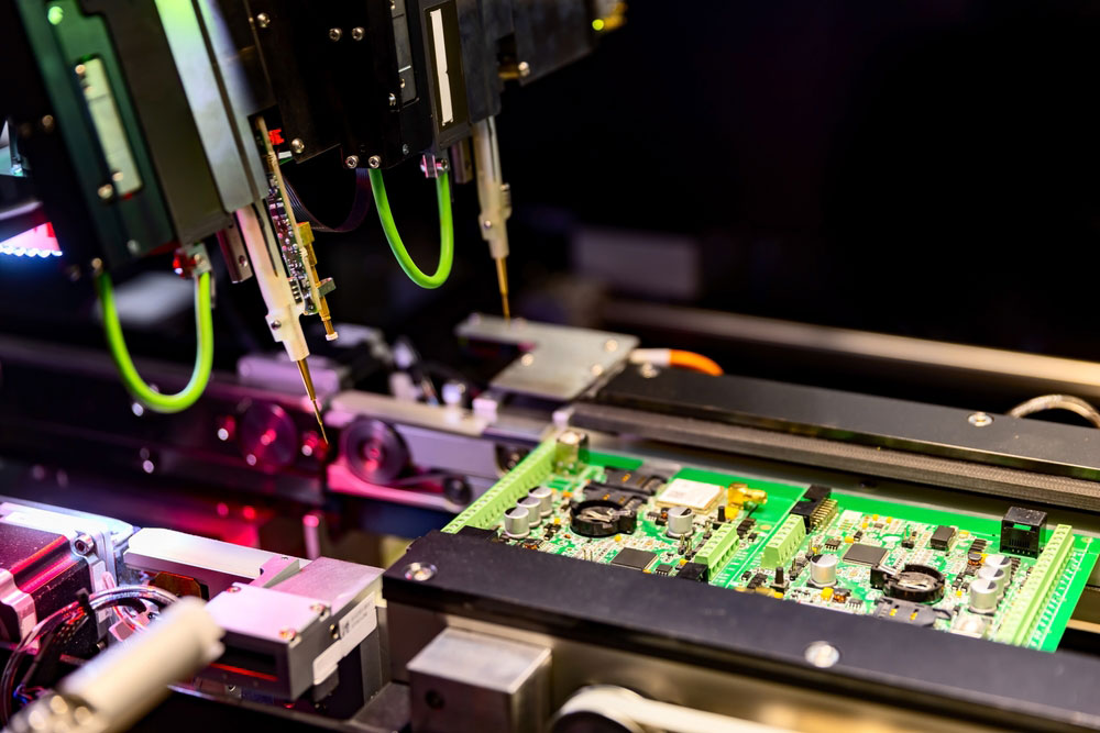 Circuit board assembly and automatic robotic flying test probes in a testing machine. Note the non-noticeable low-profile test points on the PCB.