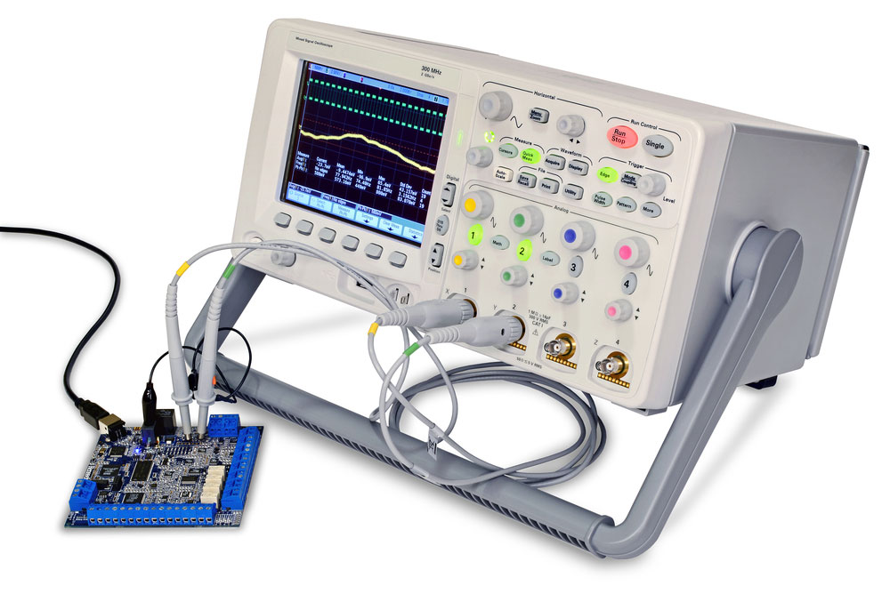 A modern digital oscilloscope measuring a PCB
