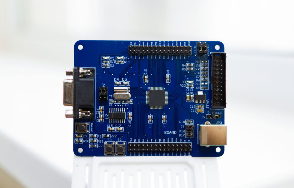 A blue dev board with a JTAG connector