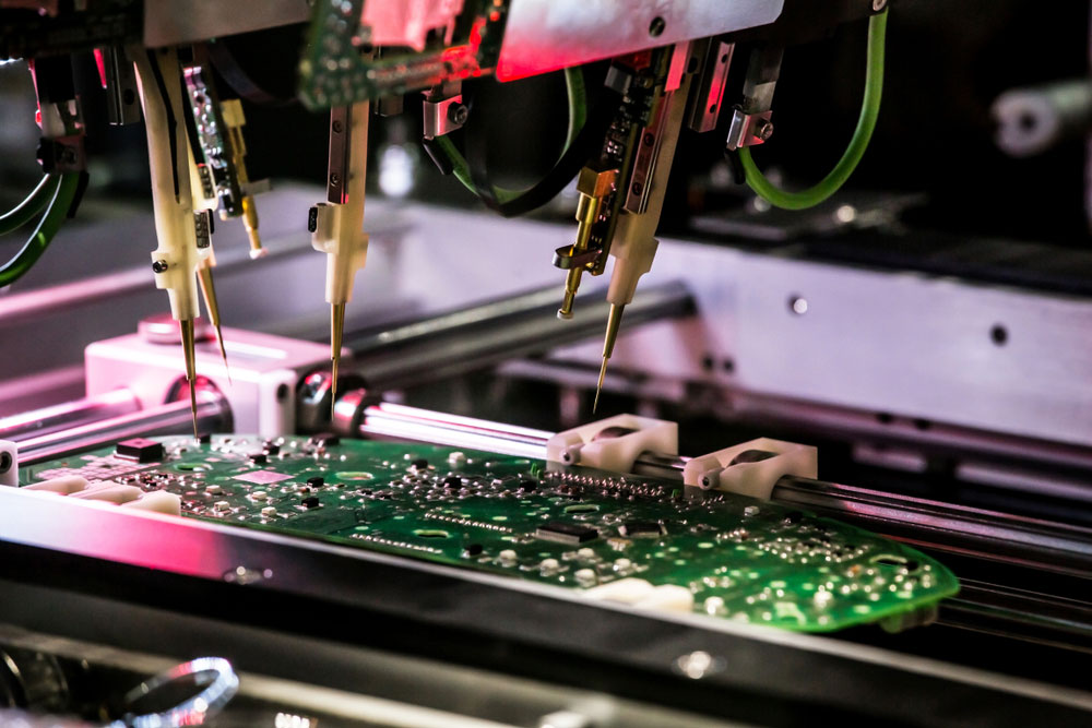 A multi-purpose flying probe system testing a PCB