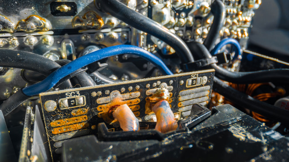 A closeup image of a damaged circuit board