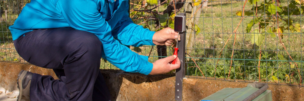 A technician repairing and assembling a photocell sensor