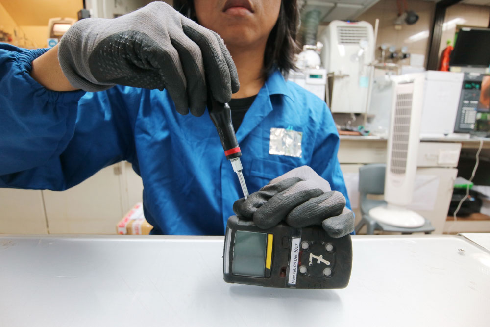 A technician calibrating a gas detector