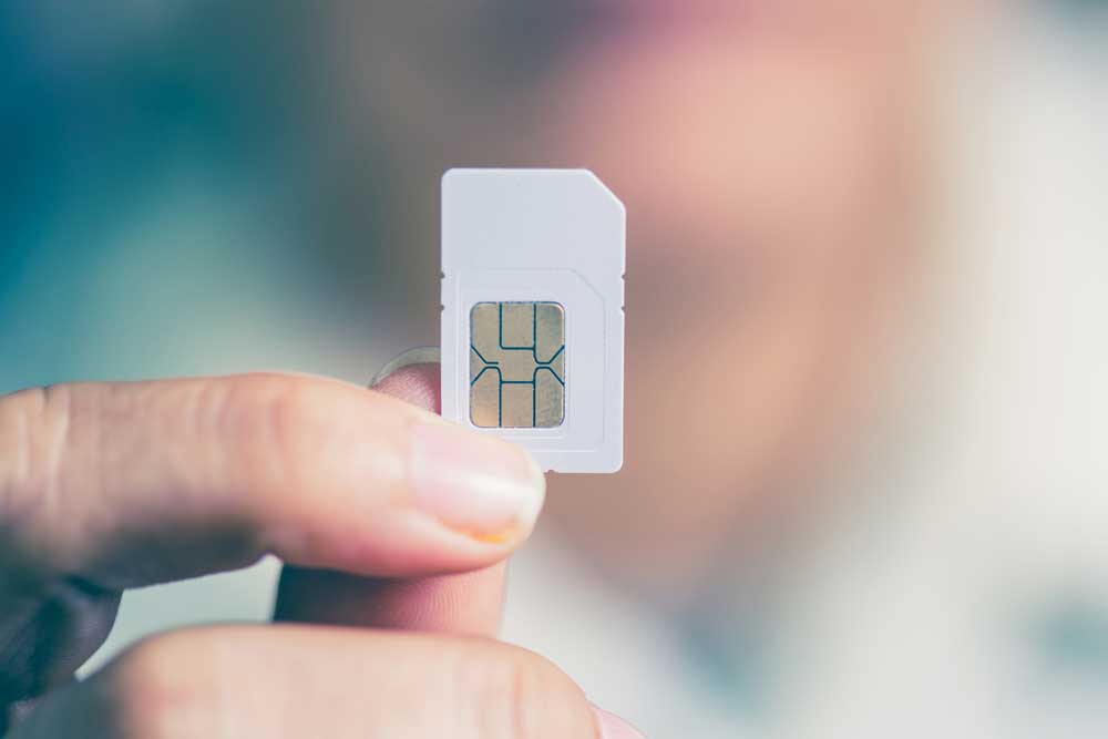 A person holding a SIM card