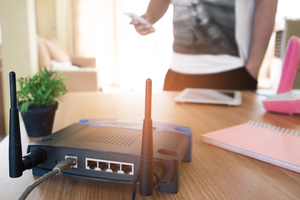 A wireless router with an ethernet cable plugged in