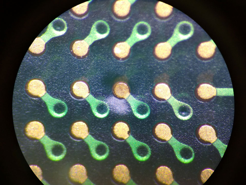 PCB pads and vias under a microscope