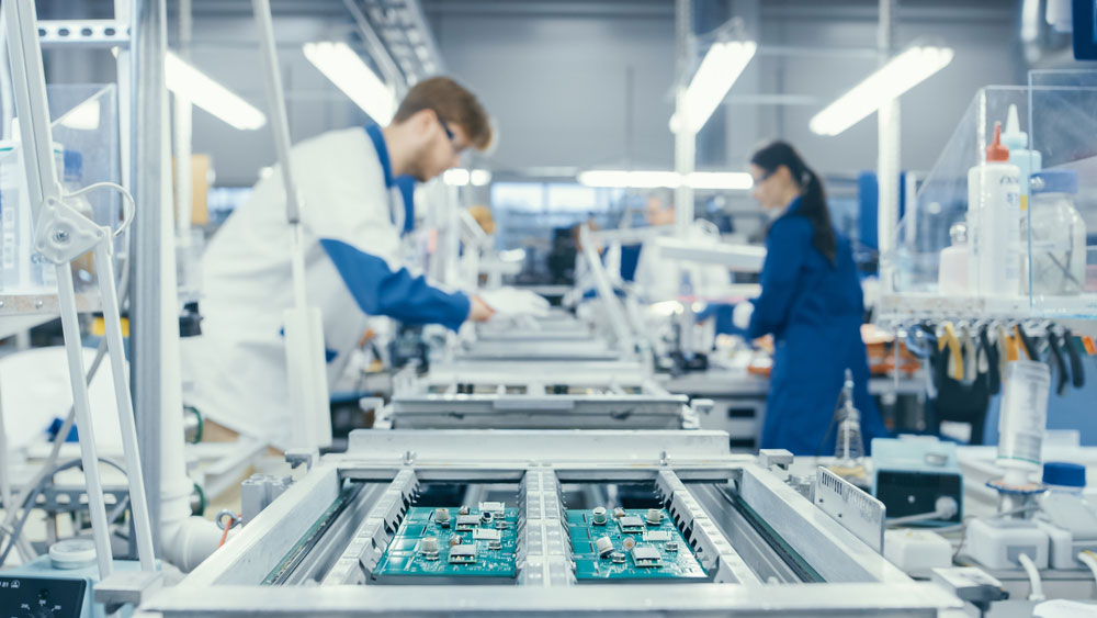 PCB Cost Estimator: Electronics factory workers assembling PCBs