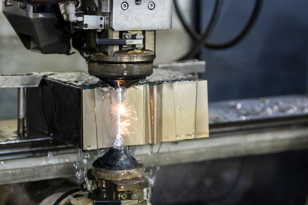 A close-up image of an electrical discharge machine at work