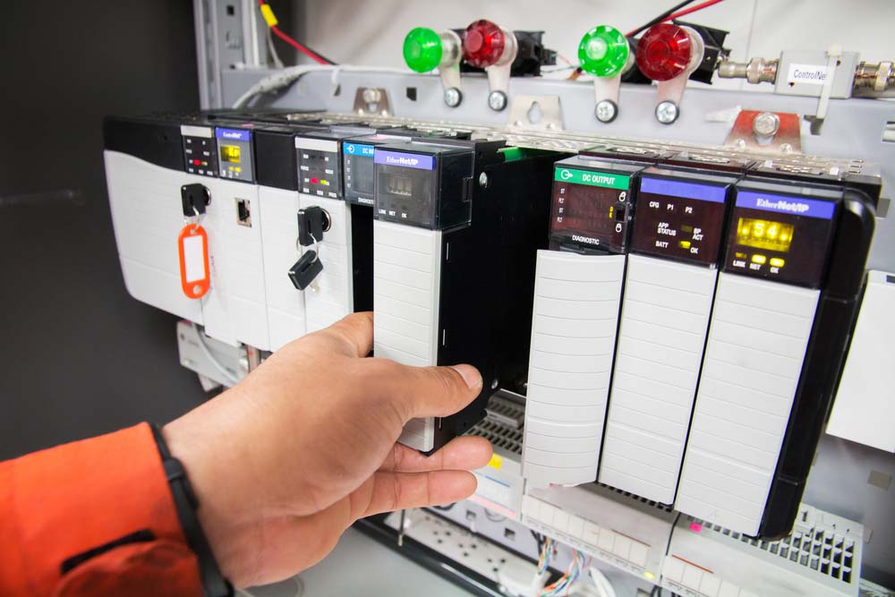 A programmable logic controller mounted on a control panel for industrial applications.