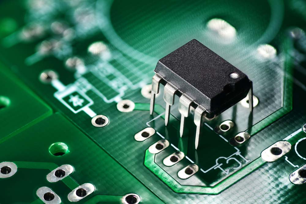 A circuit board with slots left for soldering a microcontroller.