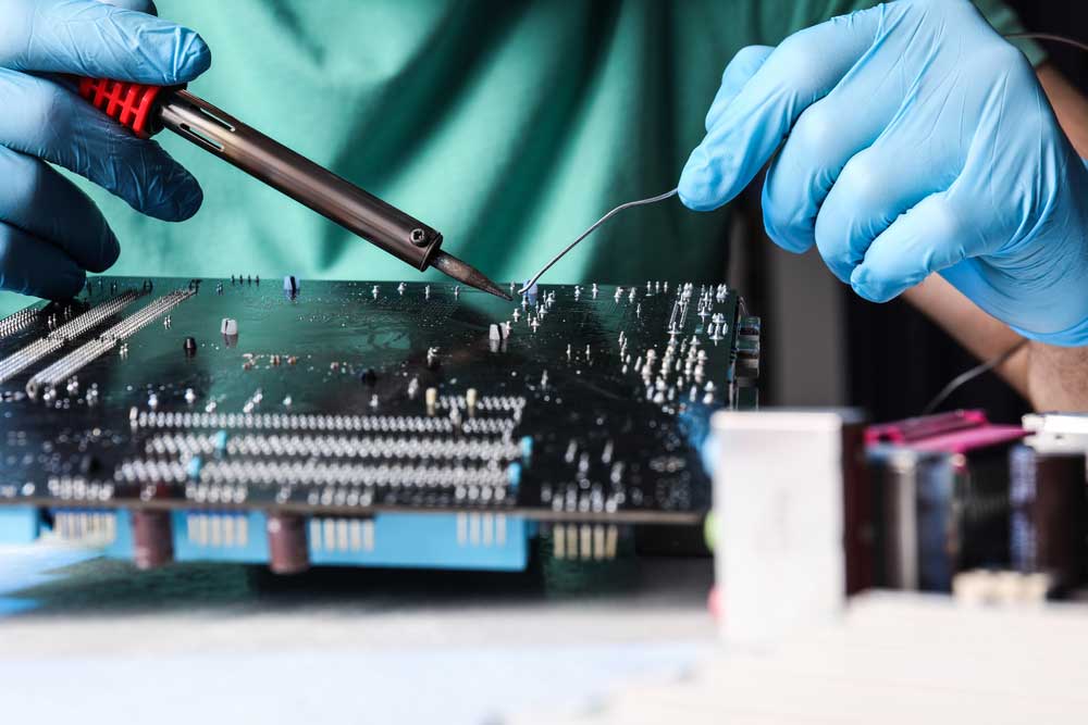 A technician using a soldering iron