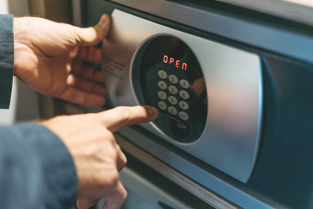 A close-up image of an electronic safe lock with a tiny screen to show the status