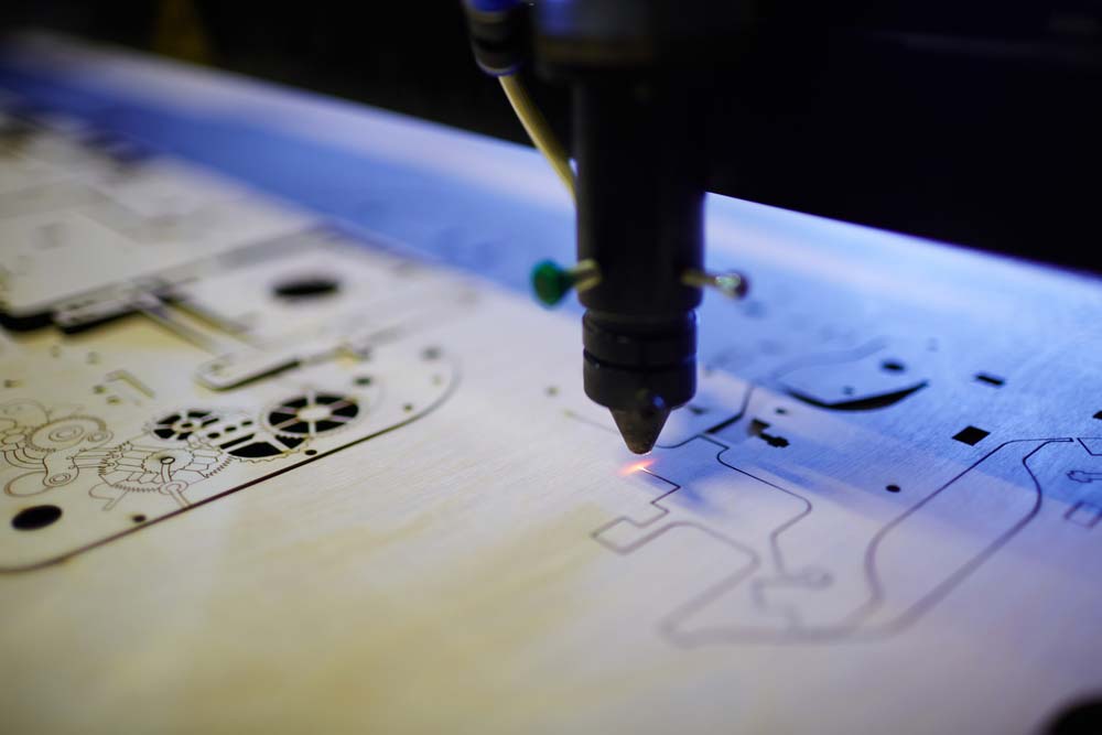 A laser cutter projecting a narrow beam on the working surface